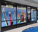 Pure Cigs West Melbourne, FL - Large-format digitally-printed perforated vinyl overlay across storefront