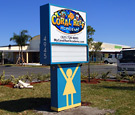 Coral Reef Academy - Pylon Sign with Readerboard and Vandal Cover. Pole cover has a girl on one side, and a boy on the other